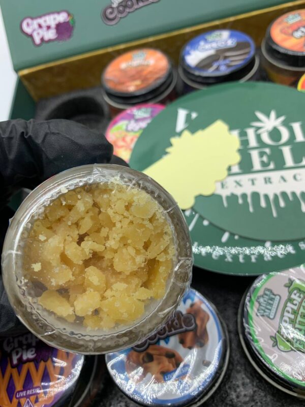 A jar of Whole Melt Extracts (Premium Live Resin), showcasing the golden concentrate ready for use in dabbing or vaping.