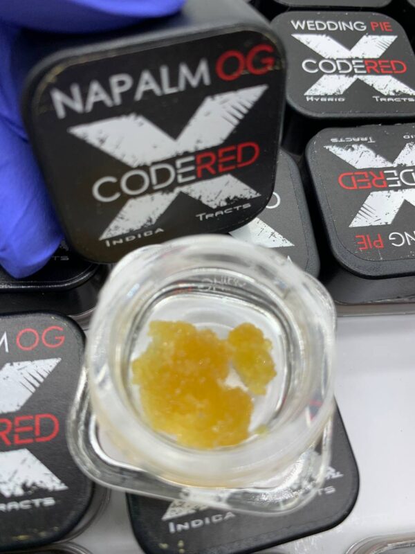 A 1g jar of Code Red Diamonds concentrate, showcasing its crystalline structure and rich THC content.